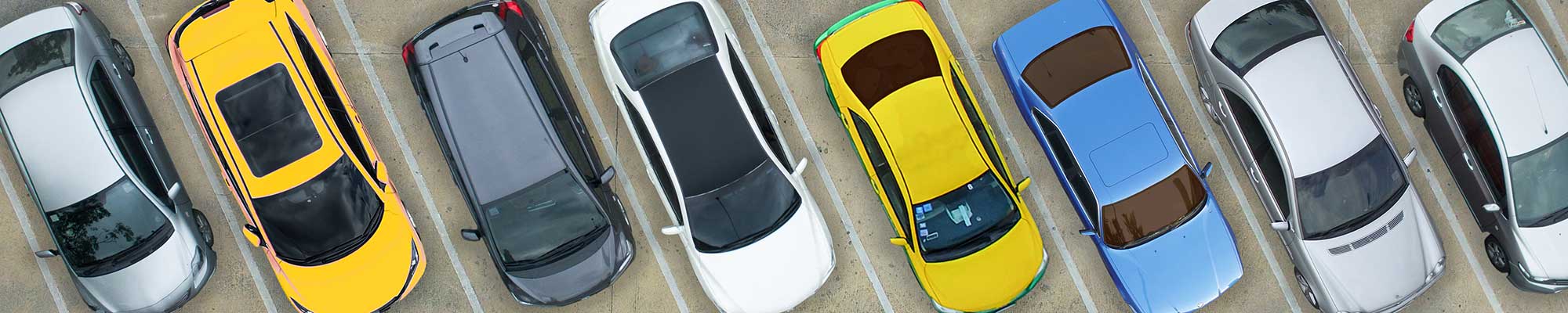 aerial shot of a row of cars in a parking lot